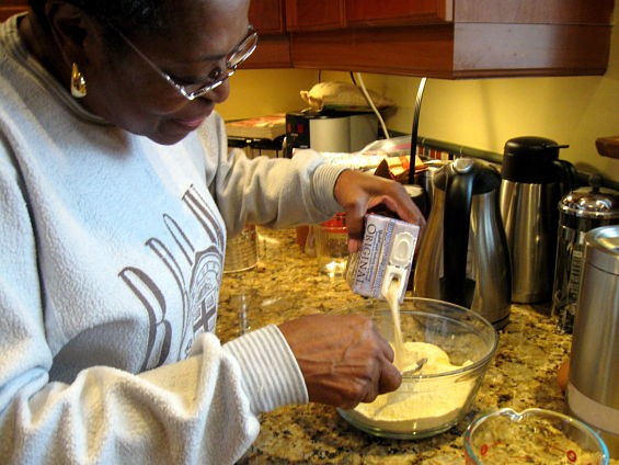Evelyn Lard mixes up a batch of cornbread. "I never used soy milk before Andria converted," she says. "I prefer buttermilk, but I'm learning to accept it." - AIMEE LEVITT