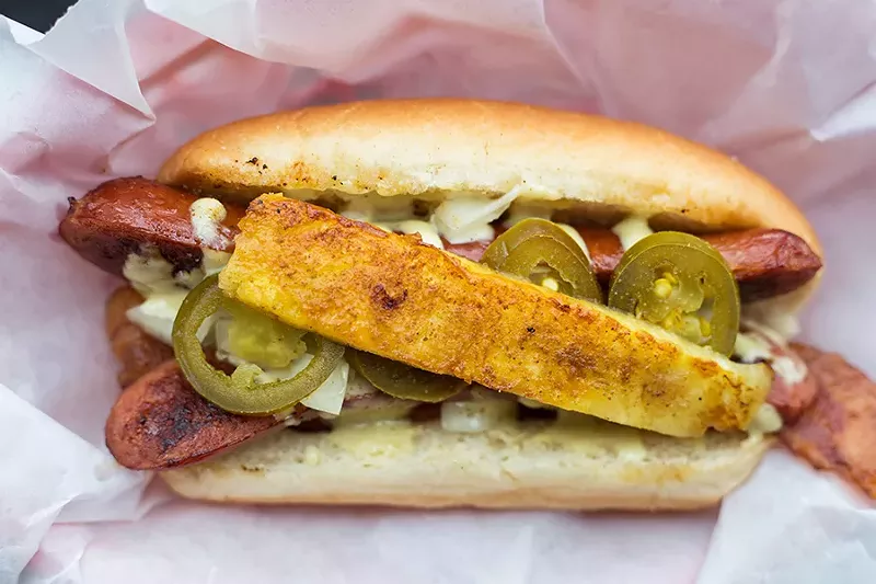 The “Volcano” is topped with peppered bacon, hot sauce, jalapeno aioli, chopped onions, jalapenos, sport peppers, seared pineapple and celery salt. - MABEL SUEN