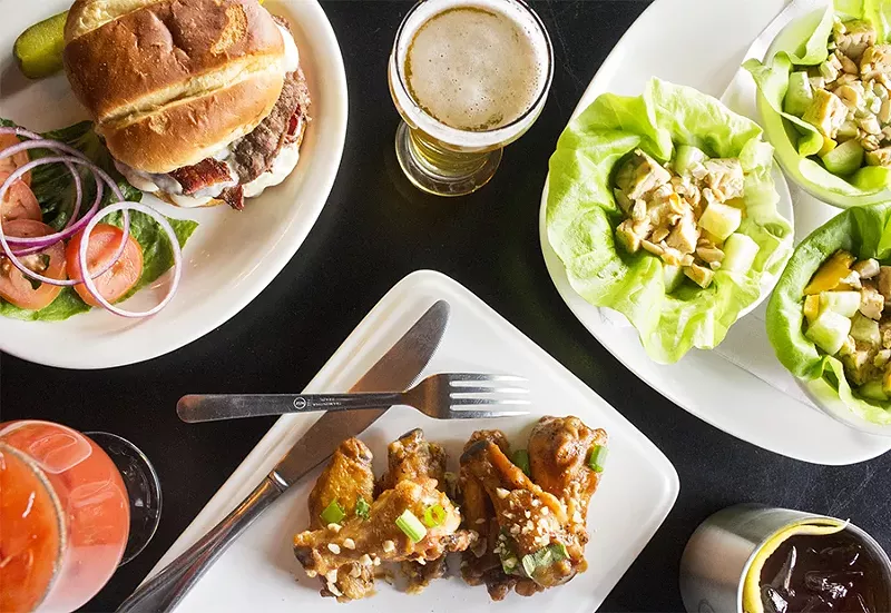 A selection of Brickyard Tavern dishes, including the burger, lettuce cups and whole wings. - PHOTO BY MABEL SUEN