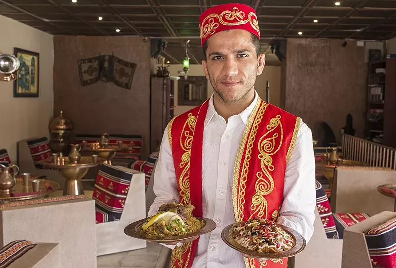 Servers wear formal Turkish dress. - PHOTO BY MABEL SUEN