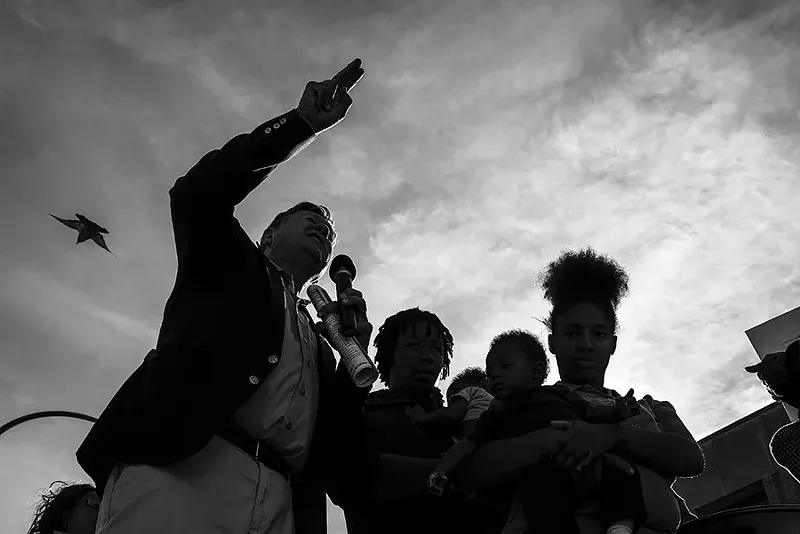 Rev. Larry Rice, left, speaks during a rally outside New Life on November 17. - PHOTO BY NICK SCHNELLE