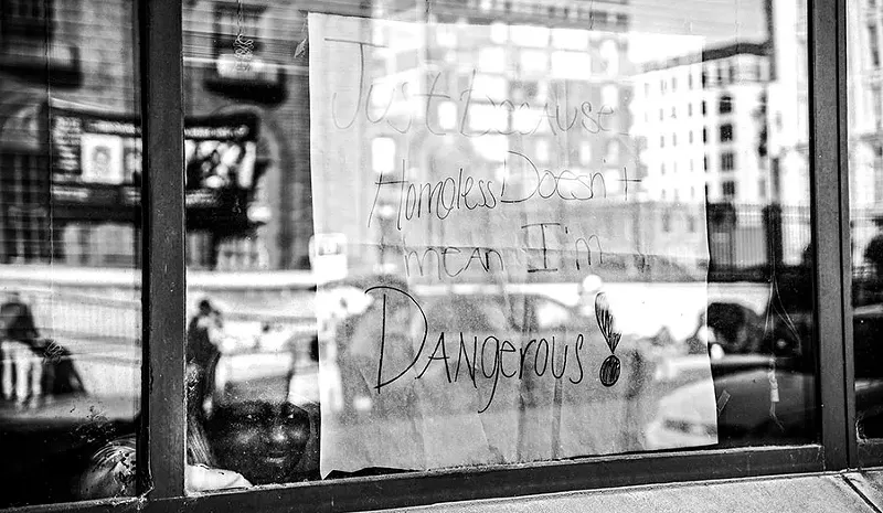 A child looks out a window of the Confluence Preparatory Academy. Homeless children attend the school, which is part of a network of charter schools that are tuition-free and operate independently of the city school system. - PHOTO BY NICK SCHNELLE