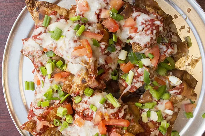 Pizza nachos are made up of fried, housemade thin-crust pizza dough, pizza sauce, tomatoes, green peppers, cheese and onions -- chicken or pepperoni is available at a slight upcharge. - PHOTO BY MABEL SUEN
