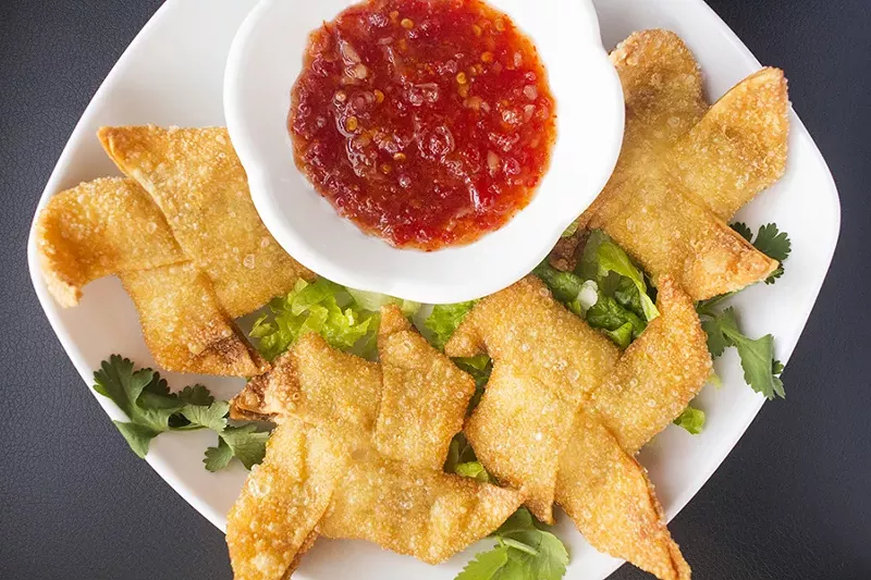 "Viet Style Cheese Wrap" are fried cheese puffs filled with cream cheese, crab meat and quail egg. - PHOTO BY MABEL SUEN