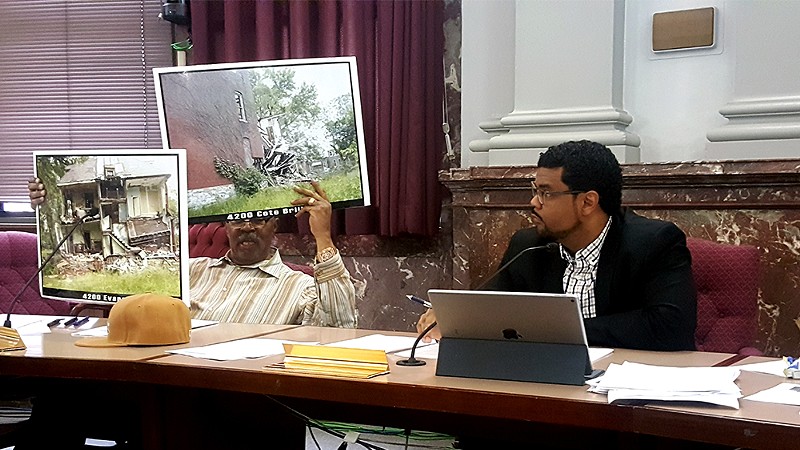 During Thursday's committee hearing, 4th Ward Aldermen Sam Moore, left, brought pictures of crumbling north city houses. - PHOTO BY DANNY WICENTOWSKI