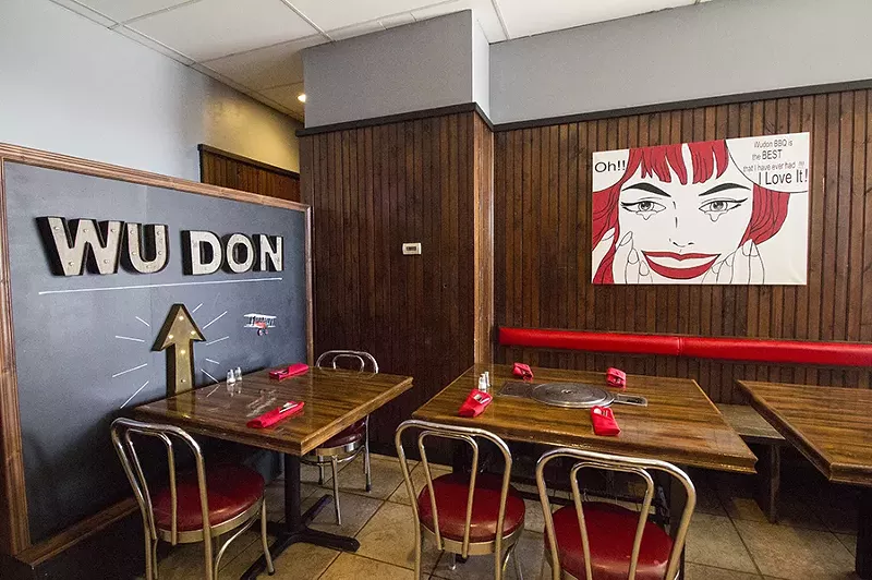 The handsome dining room features pop art. - PHOTO BY MABEL SUEN