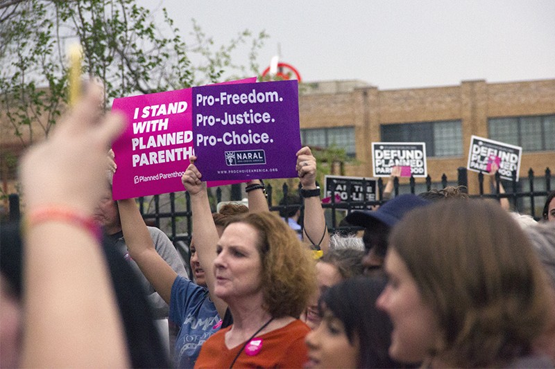 Planned Parenthood supporters at a rally in April. - DANNY WICENTOWSKI