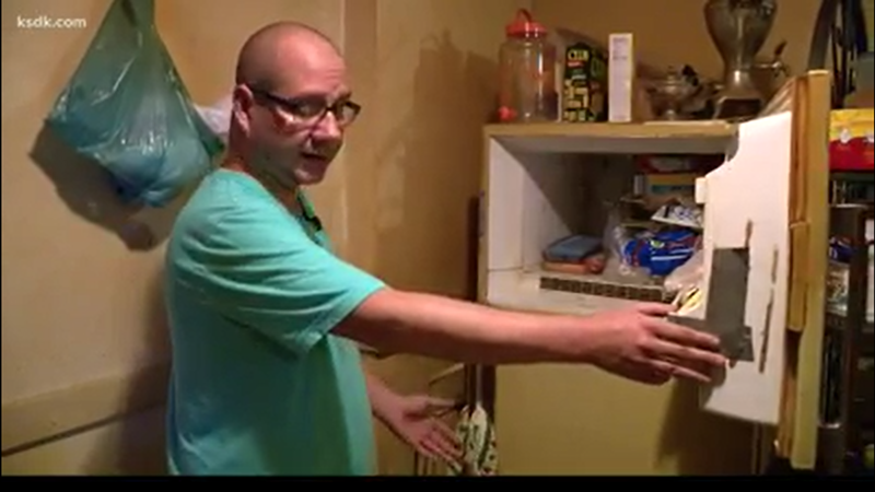 Adam Smith opens the freezer where a baby's body has been stored for decades. - SCREENSHOT / KSDK