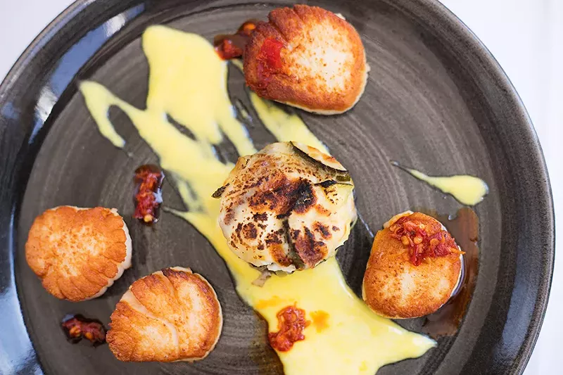 The capesante pairs pan-seared scallops with saffron cream, neonata and vegetal sfogliatella. - MABEL SUEN