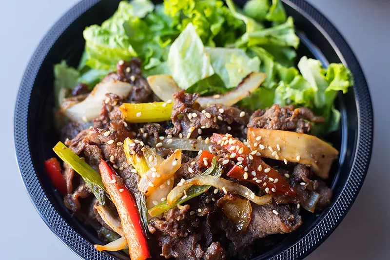 The beef bulgogi bowl features a subtly sweet, garlicky, soy-kissed mound of sliced beef. - MABEL SUEN