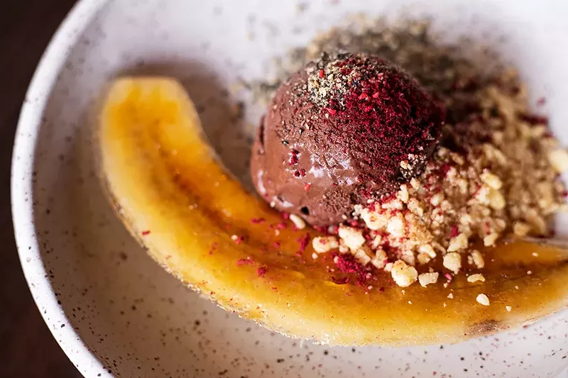 Coconut chocolate fudge dessert with banana brûlée and black sesame candy crisp. - MABEL SUEN