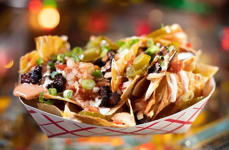 Tiny Chef's Korean nachos with bulgogi steak, cheddar, monterey jack and pepper jack cheeses, pico de gallo, jalapeños, sour cream, Dragon Sauce and scallions. - MABEL SUEN