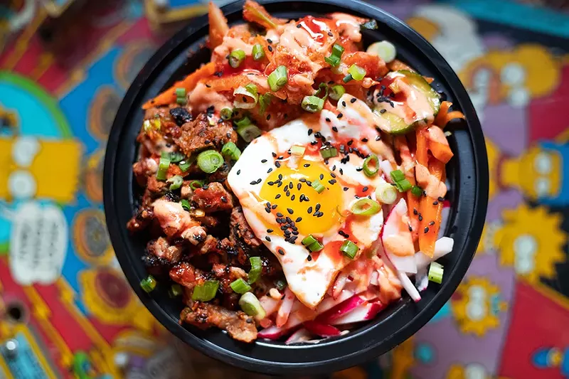 Tiny Chef’s bulgogi steak bibimbap bowl with vegan kimchi, sesame seeds, cucumber-carrot-sesame salad, radishes, scallions, Japanese-style rice, a fried egg and Dragon and Pixie sauces. - MABEL SUEN