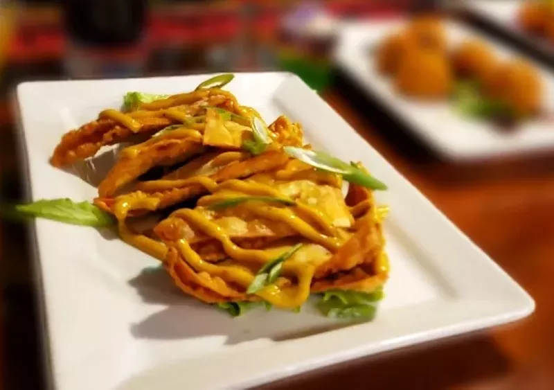 Cajun chicken and andouille wontons are one of Carnival's must-try shareable plates. - KRISTEN FARRAH
