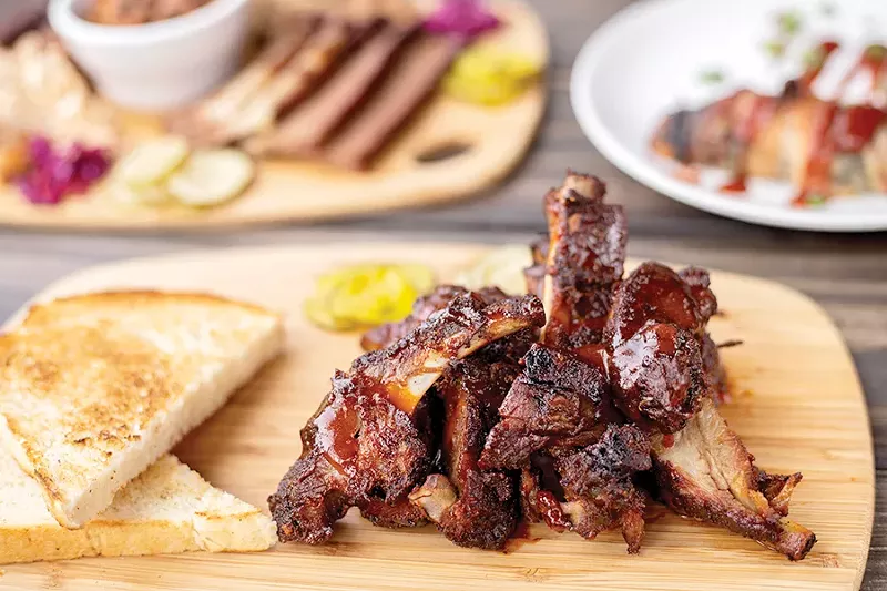Knockout’s Trashed Ribs are smoked, sliced, seasoned and fried before being lightly sauced with Texas-style barbecue sauce. - MABEL SUEN