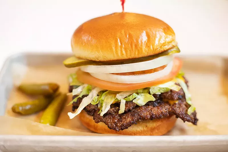 A griddled double cheeseburger with American cheese, lettuce, tomato, onion, pickles and sport peppers. - MABEL SUEN