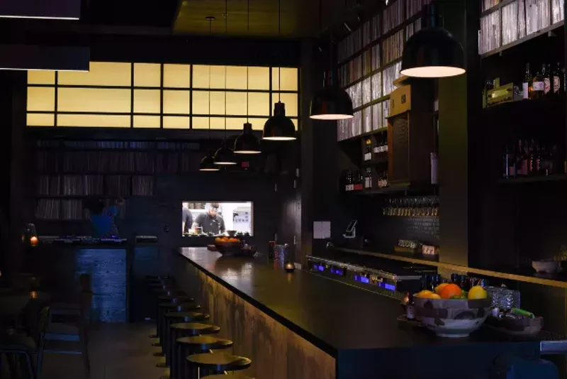 The massive bar at Takashima is bookended by the kitchen window and DJ booth on one side of the space. - TRENTON ALMGREN-DAVIS