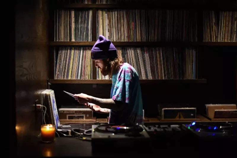 Takashima music director Paul Fullerton in the bar's DJ booth.