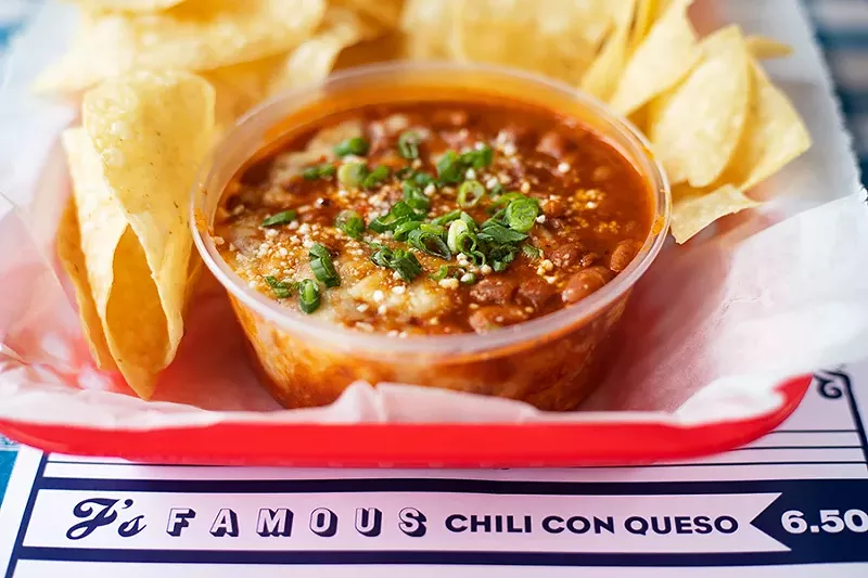 Chili con queso with brisket chili, Chihuahua cheese and green onions. - MABEL SUEN
