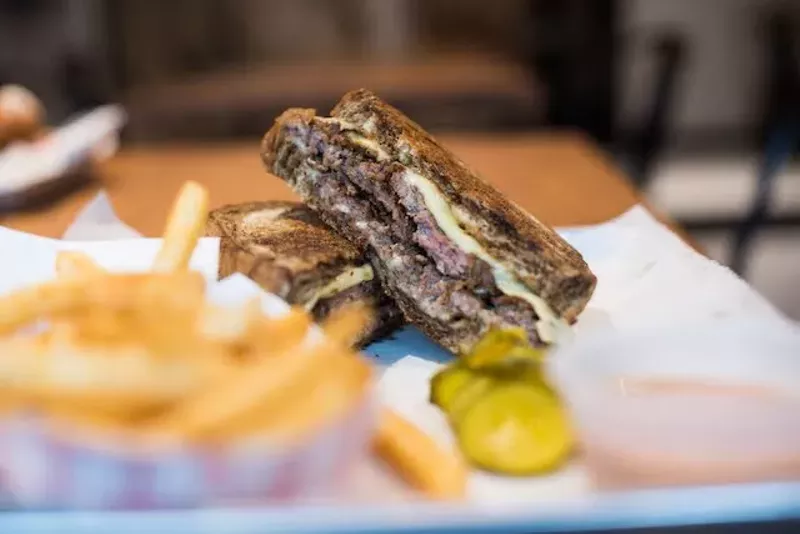 Another view of the pastrami sandwich with a side of fries. - TRENTON ALMGREN-DAVIS