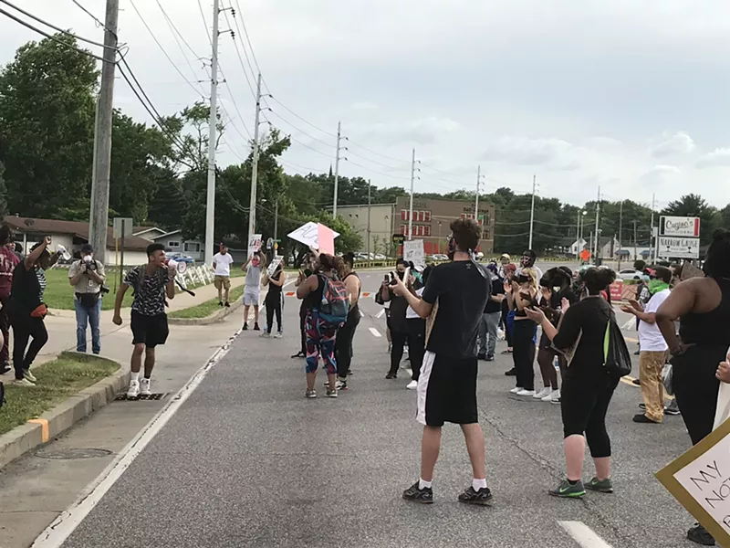 Protesters outside of the Florissant police station demanded an officer who hit a suspect with his car be charged. - MIKE FITZGERALD