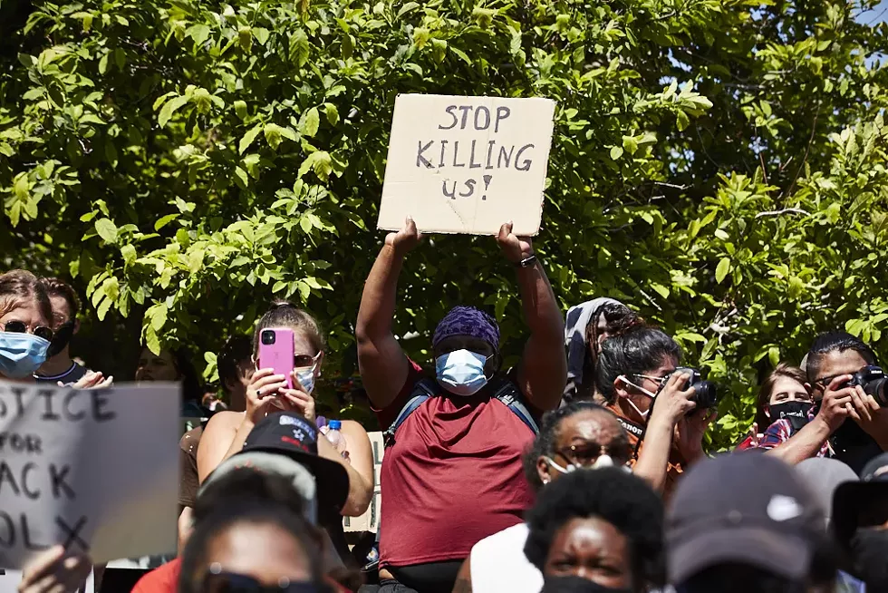 Among thousands at the Protest Against Police Murder, a woman has a request. - THEO WELLING