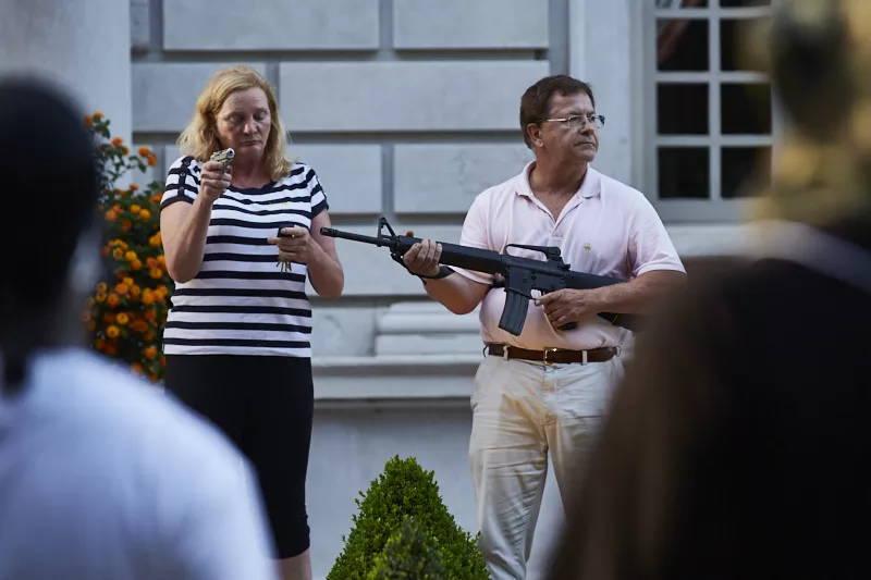 Patricia and Mark McCloskey confront protesters on June 28. - THEO WELLING