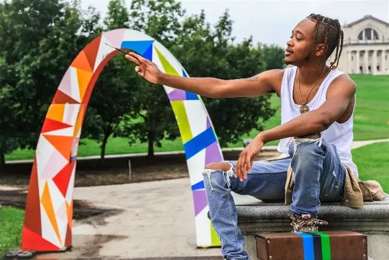 Artist Brock Seals explains the symbolism of the arch he designed. - NICHOLAS COULTER