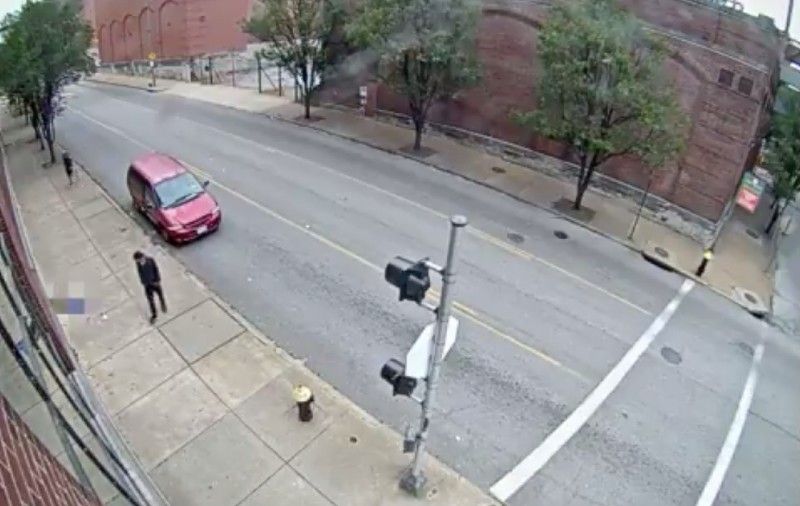 A screen shot shows the suspect in black and a red minivan next to the woman, who is blurred out. - ST. LOUIS POLICE