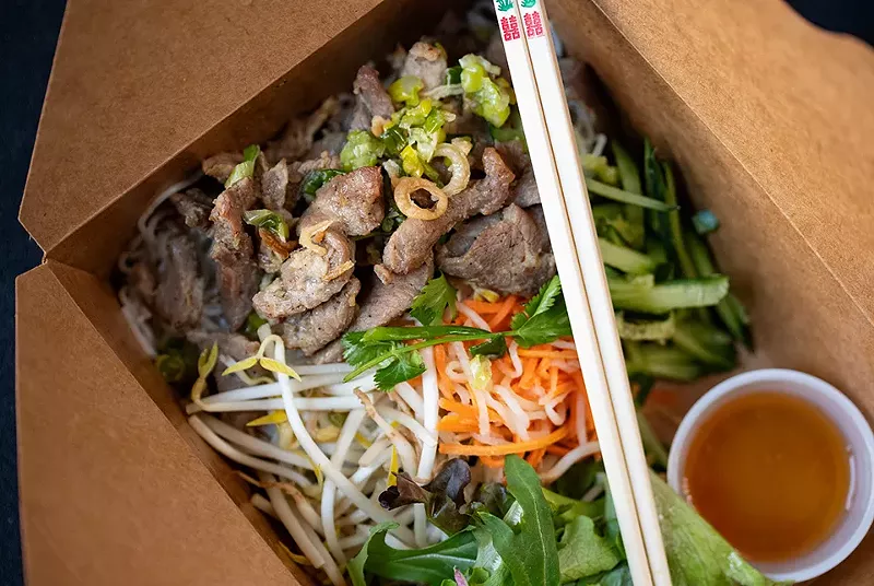 Grilled pork noodle bowl with rice noodles, mixed greens, bean sprouts, cilantro, pickled daikon, carrots and citrus-lime sauce. - MABEL SUEN
