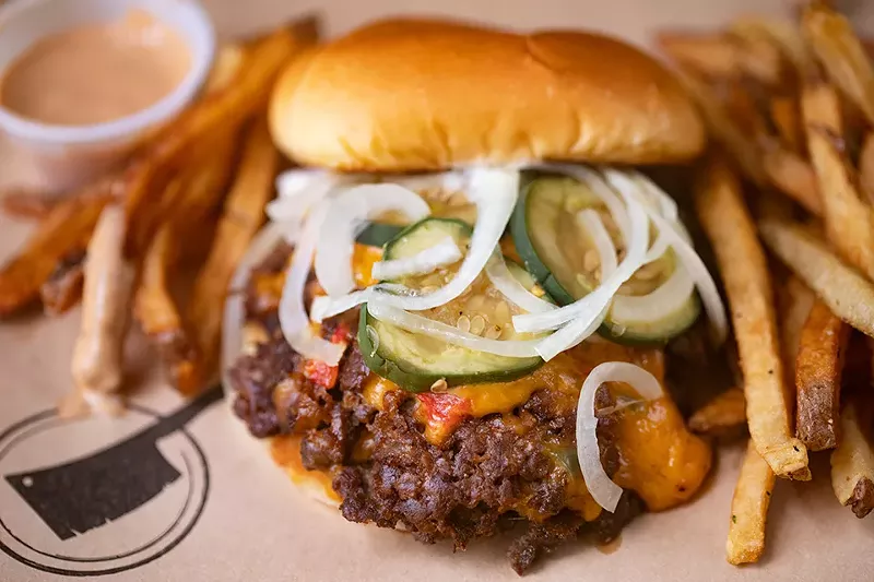 Pimento smash burger with two five-ounce patties, white pimento cheese, mayo, shaved onions, and bread and butter pickles. - MABEL SUEN