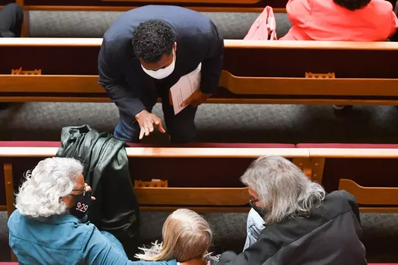 Rev. Emmanuel Cleaver III welcomes congregants to St. James United Methodist Church in Kansas City, Missouri, where in-person services were paused for more than a year due to the covid-19 pandemic. - CARLOS MORENO/KCUR
