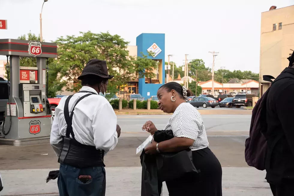 Pastor Pam speaking to people at the Phillips 66 in the neighborhood trying to hand out as many life-saving supplies as possible to as many people as she can reach. - ERIN MCAFEE