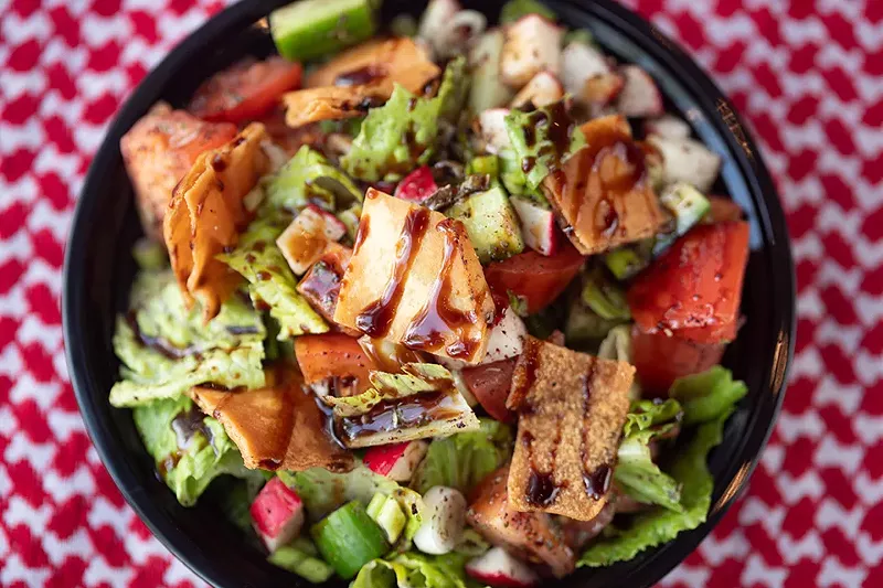 Fattoush salad with romaine, tomatoes, cucumbers and green onions, topped with pita chips, olive oil lemon dressing and pomegranate molasses. - MABEL SUEN