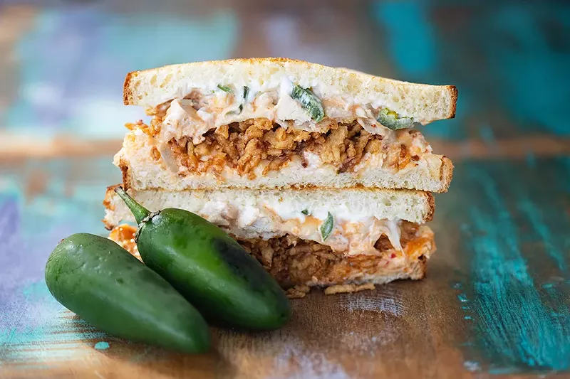 Chicken popper sandwich with shredded chicken, garlic, jalapeños, cream cheese, provolone and crispy onions. - MABEL SUEN