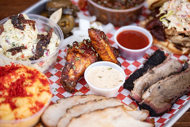 A selection of items from Navin's BBQ: mashed potatoes salad, chicken wings, pinto beans, The Mess sandwich, mac'n'cheese, slicked turkey and sliced ​​brisket.  - MABEL SUEN