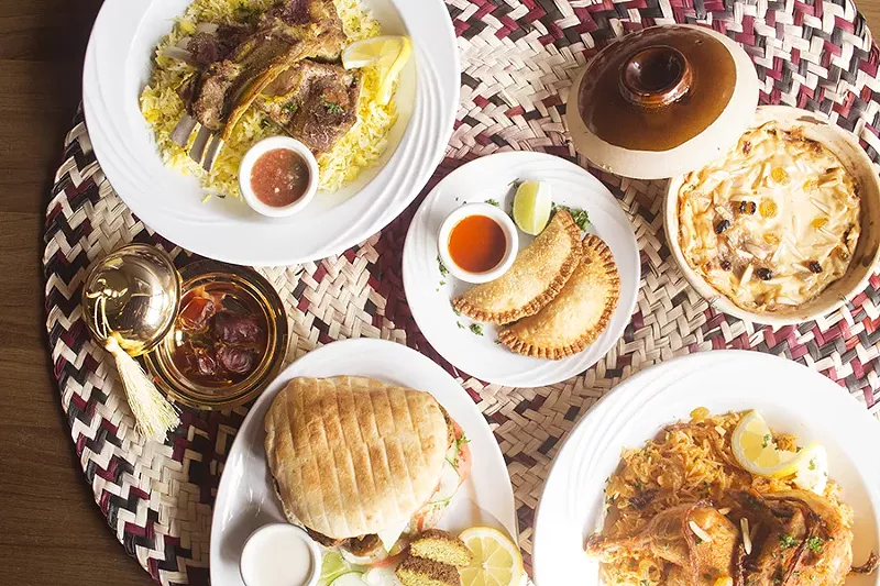 A selection of dishes from the Palm Trees: Kabli Hijazi lamb, Om Ali, Kabsa chicken, sambusas, Mandi lamb and the falafel sandwich. - PHOTO BY MABEL SUEN