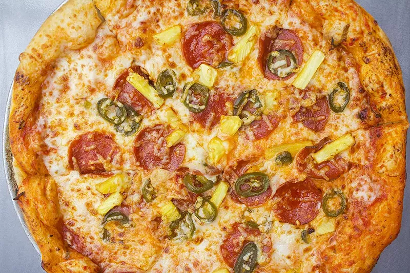 The "Spicy Maui Wowie" pizza includes mozzarella, parmigiana, spicy pepperoni, pineapple and jalapenos. - PHOTO BY MABEL SUEN