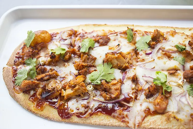 'Zza's "Postrio" takes it flavor from Sweet Baby Ray's barbecue sauce, along with smoked gouda, red onion and cilantro. - PHOTO BY MABEL SUEN