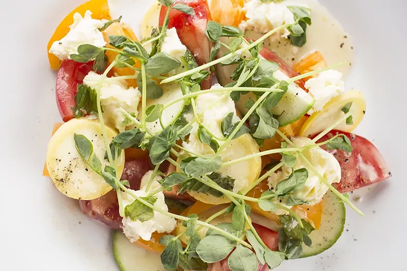 Snax offers seasonal vegetable salads, like this tomato and squash salad with mozzarella. - PHOTO BY MABEL SUEN