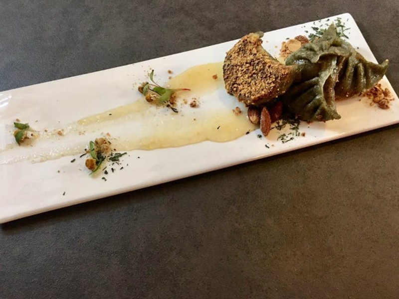 A dessert potsticker, "the Asian Cherry Bomb," uses green tea matcha dough with a mascarpone pistachio filling and is finished with a lemon white tea sauce.