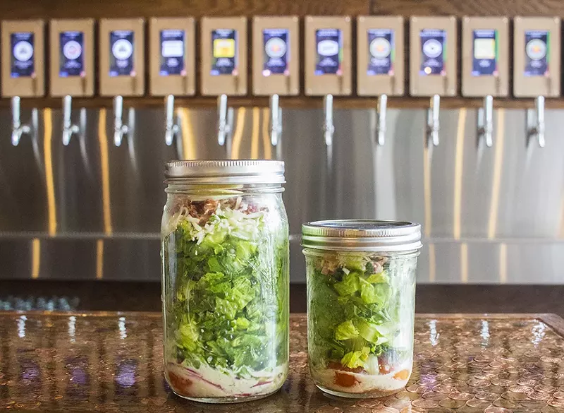 he "Tapped Mason Jar Salad" comes in two sizes with romaine lettuce, bacon, egg, red onion, tomato, a four-cheese blend and house vinaigrette. - PHOTO BY MABEL SUEN