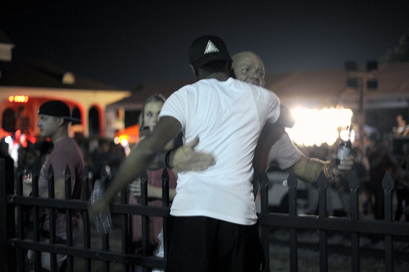 Many revelers were hostile to the protest — but one man offered a hug. - PHOTO BY KELLY GLUECK