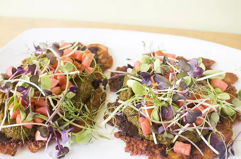 Celery pancakes are made with chickpea and topped with fermented radish, collard saag, ancho chile and garlic honey. - MABEL SUEN