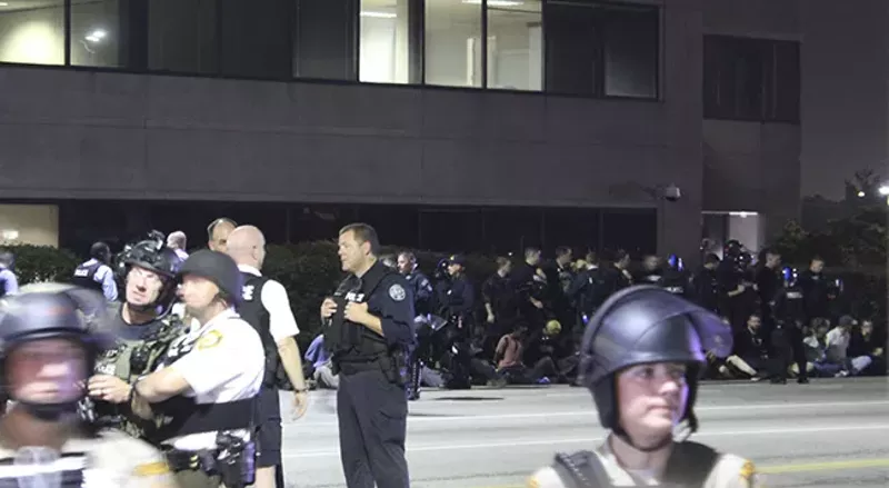 Rossomanno stands in Downtown West as officers corral protesters who blocked the highway. - DOYLE MURPHY