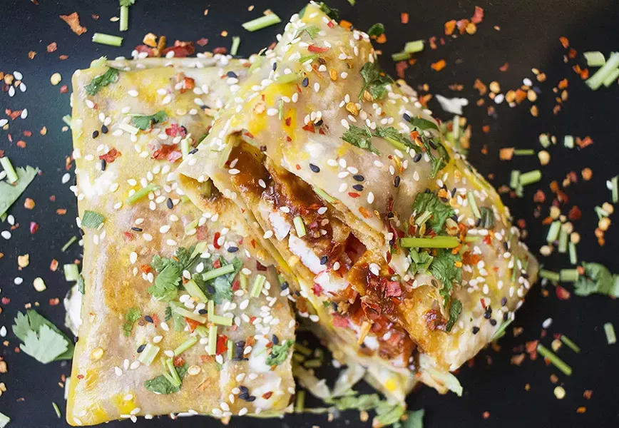 The crab-meat stick jianbing comes with scrambled egg, sesame, scallions, cilantro, lettuce, Chinese pickles and crunchy wonton. - MABEL SUEN