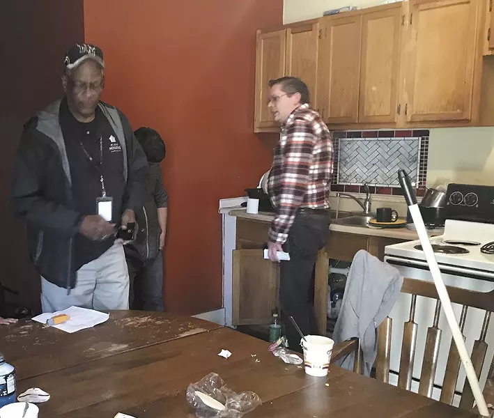 Nathan Cooper, right, tells an inspector he's not to blame for the home's condition. - CAITLIN LEE