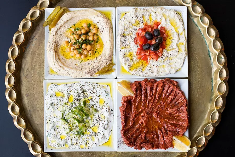 A selection of Levant's cold appetizers and salads: hummus, baba ganoush, yogurt cucumber salad and mouhamara. - MABEL SUEN