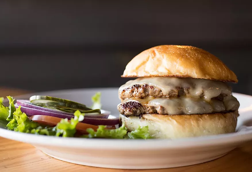 Frisco Barroom's double burger is topped with cheese, lettuce, tomato, onion, pickle and mustard relish. - MABEL SUEN