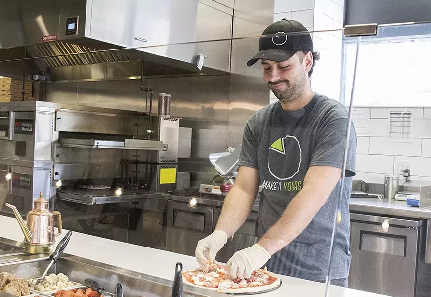 A pizza maker at work at Doughocracy's first-ever location in the Delmar Loop. - PHOTO BY MABEL SUEN